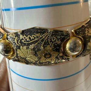 This is a vintage damascene link bracelet with a box clasp and safety chain